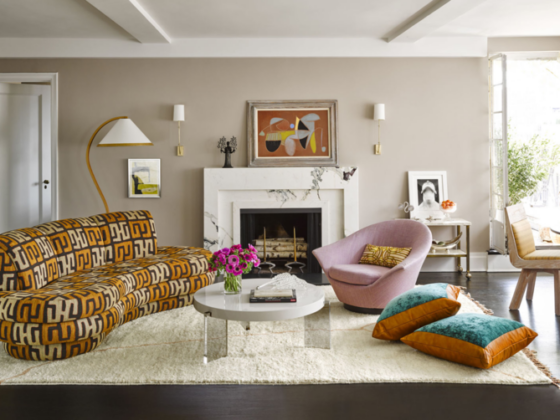 fabulous curved sofa in a leopard orange and white print with pink chair, marble coffee table, shag rug and turquoise pillows
